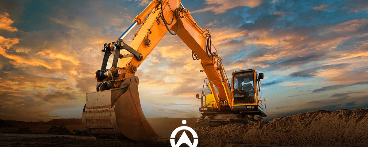 An orange excavator with a large bucket, set against a dramatic sunset sky, is positioned on a construction site.