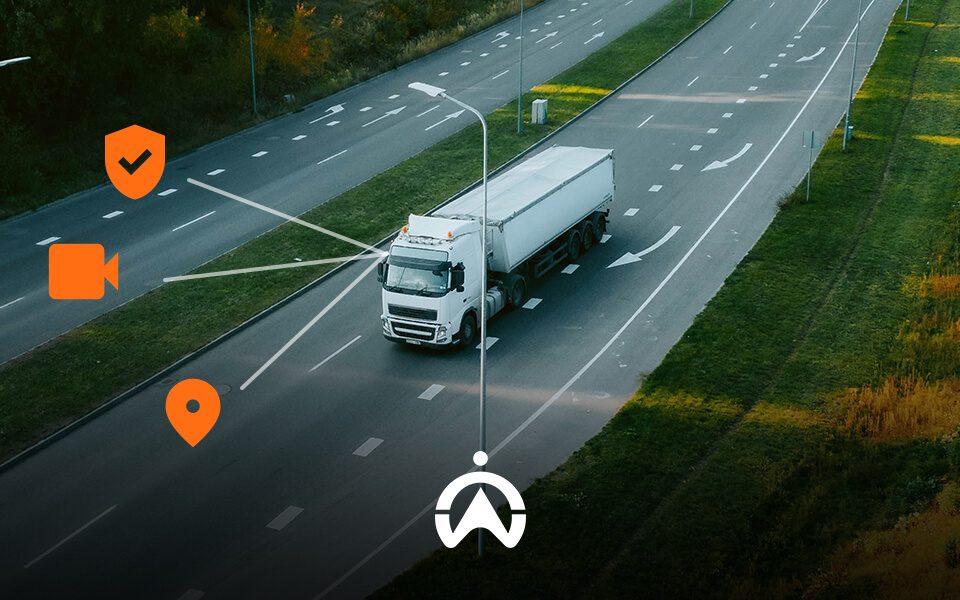 Aerial view of a white truck on a road, with icons representing security, video, and location tracking above it.