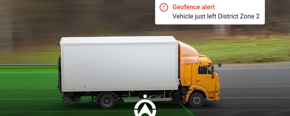 A yellow truck on a road, accompanied by a geofence alert indicating it has exited District Zone 2. Green zone markings visible.