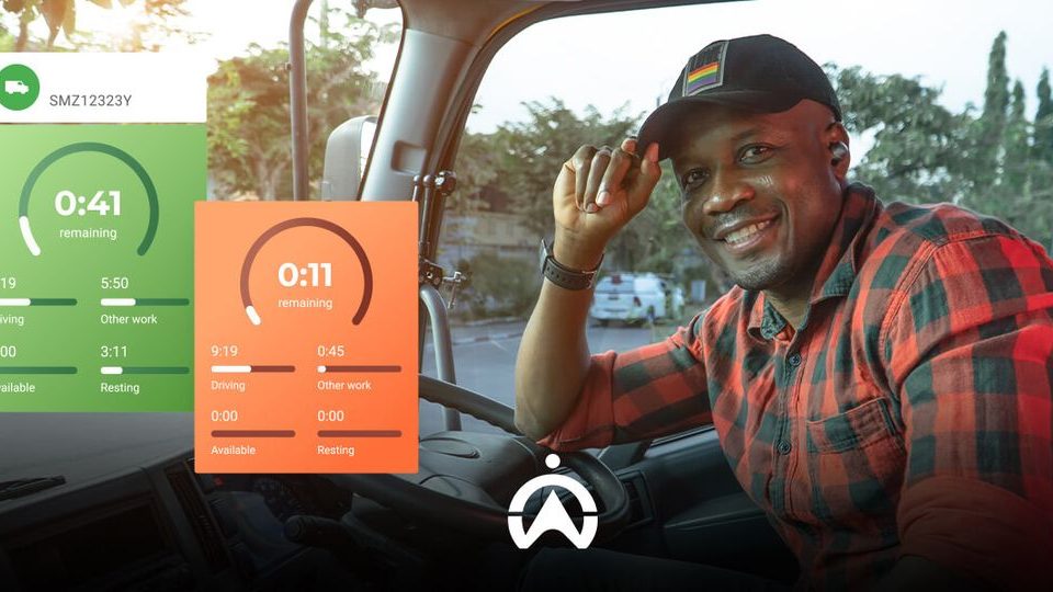 A truck driver in a plaid shirt rests in the cab, monitoring time remaining for driving and work tasks displayed on screen.