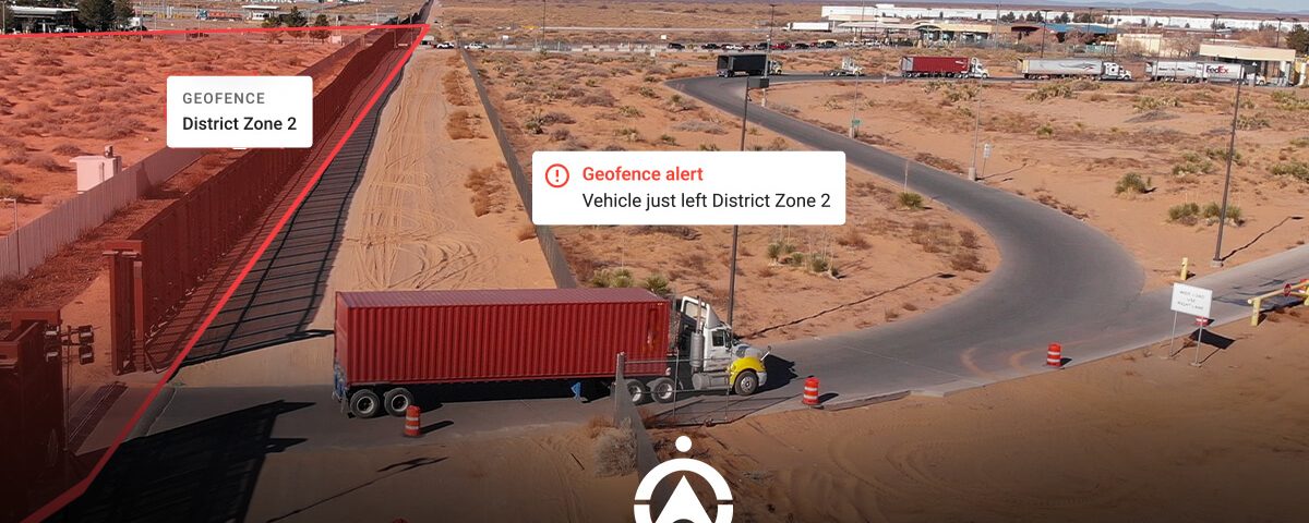 A truck exits a geofenced area marked "District Zone 2," with a notification alert on the image highlighting the boundary.